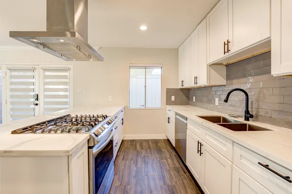 a kitchen that has a sink and a stove