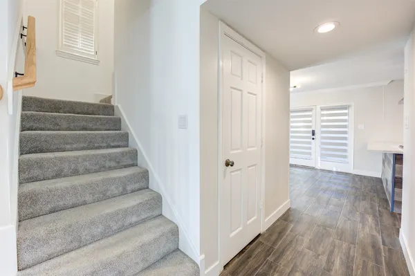 a view of entryway with wooden floor and stairs