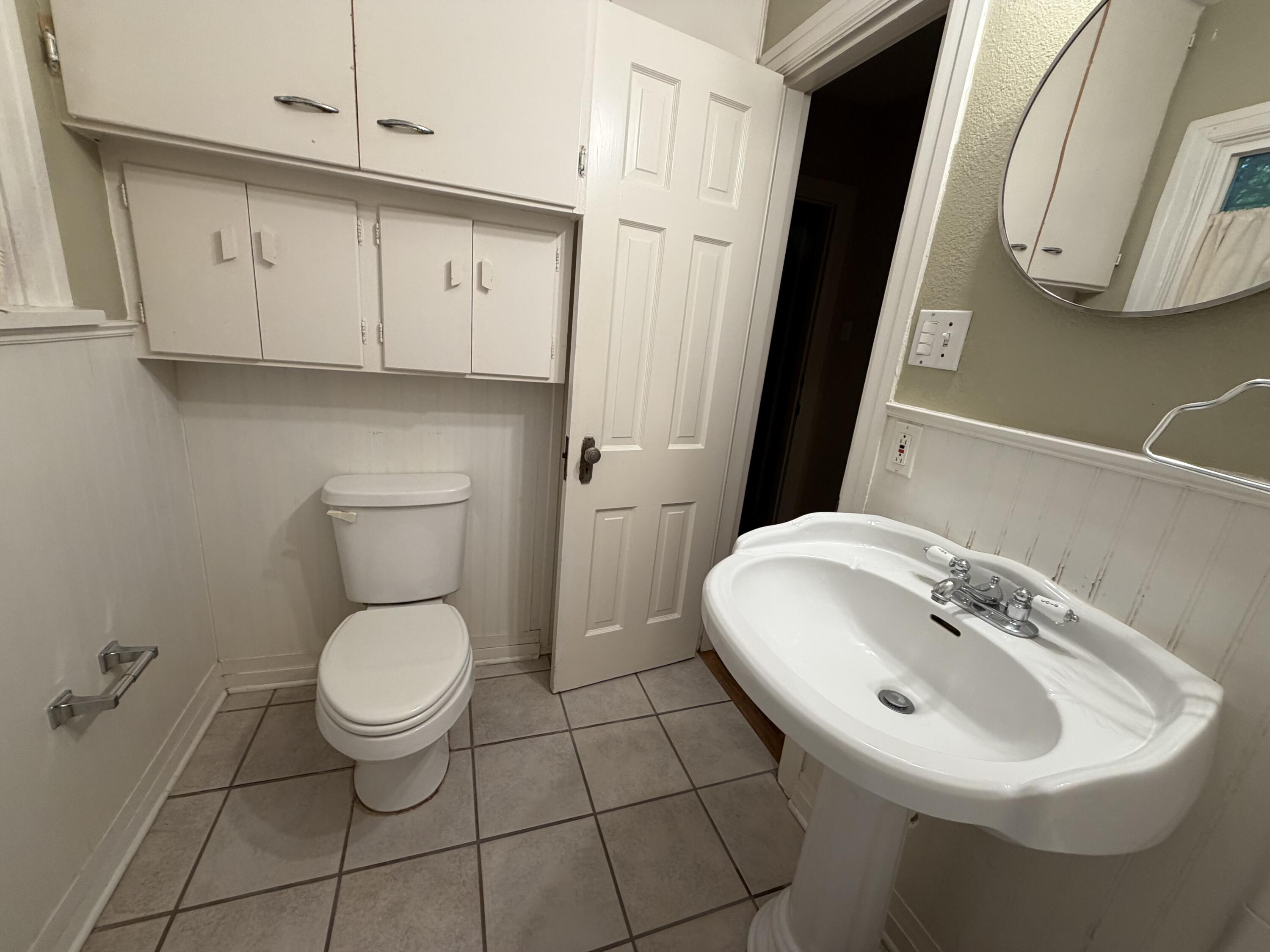 3110 22nd Street Lubbock, TX 79410 - Photo 17 of 22 a bathroom with a sink a toilet and mirror