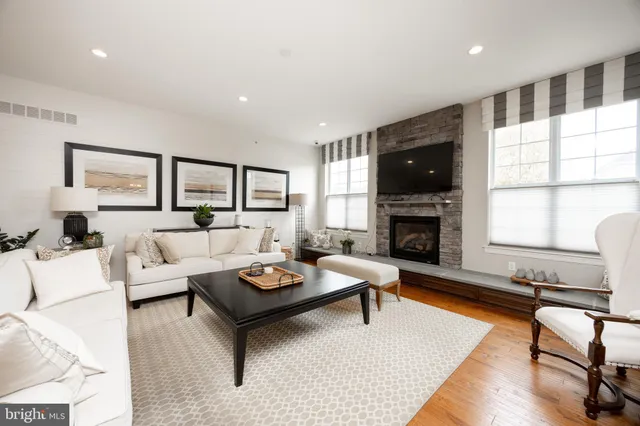 a living room with furniture fireplace and flat screen tv