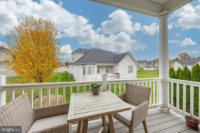 a view of a chair and table on the deck