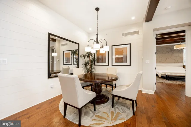 a dining room with furniture and wooden floor