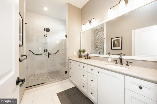 a bathroom with a double vanity sink mirror double and shower