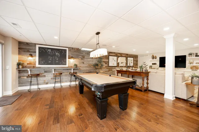 a room with lots of furniture and view of kitchen