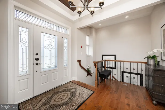 a view of a hallway with wooden floor and windows