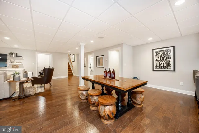 a room with furniture pool table and chairs