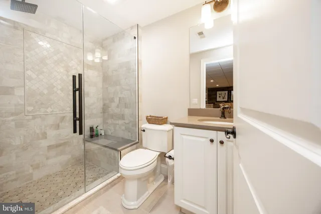a bathroom with a toilet and a shower