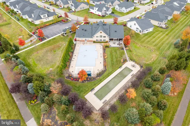 an aerial view of a house with a garden and swimming pool