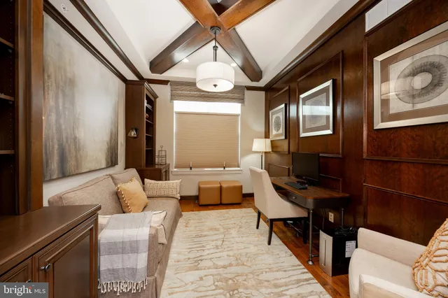 a living room with furniture a piano and a flat screen tv