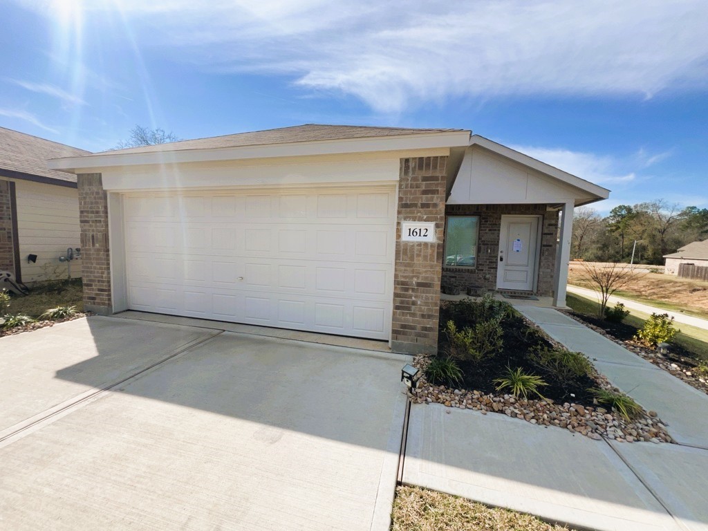 1612 Colina Creek Conroe, TX 77301 - Photo 1 of 33 a view of a house with a yard