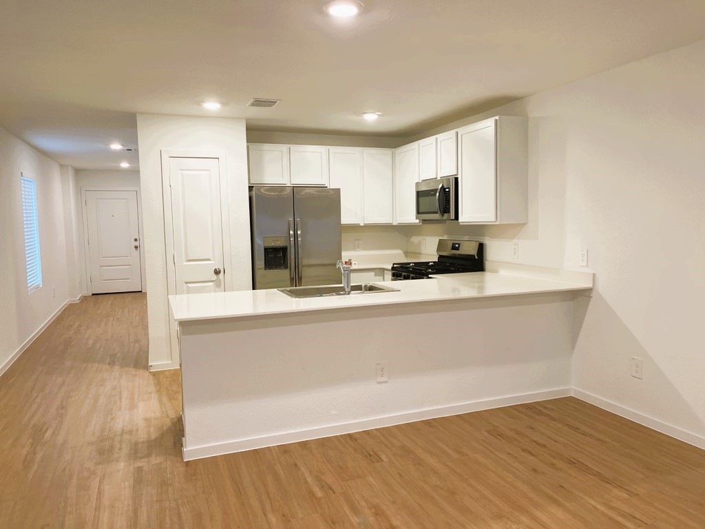 1612 Colina Creek Conroe, TX 77301 - Photo 16 of 33 a view of kitchen with stainless steel appliances refrigerator sink and cabinets