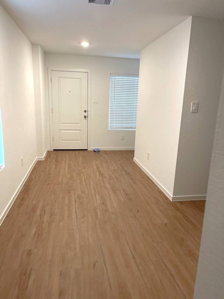 1612 Colina Creek Conroe, TX 77301 - Photo 23 of 33 wooden floor in an empty room with a window