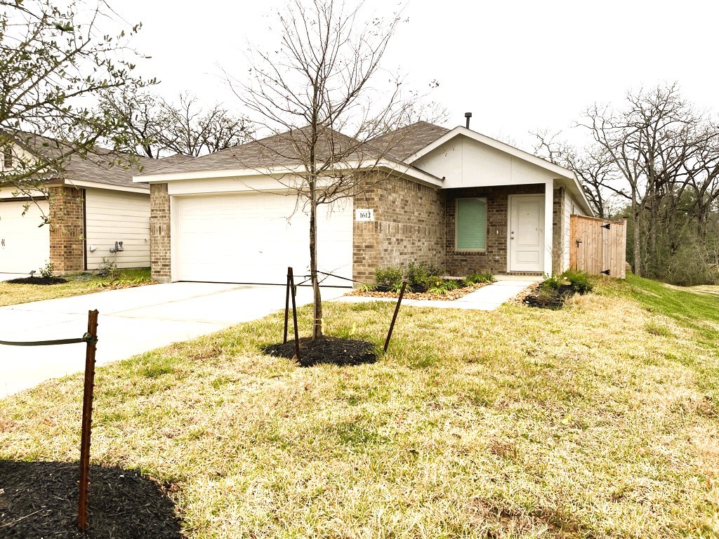 1612 Colina Creek Conroe, TX 77301 - Photo 26 of 33 a view of a house with snow on the wall