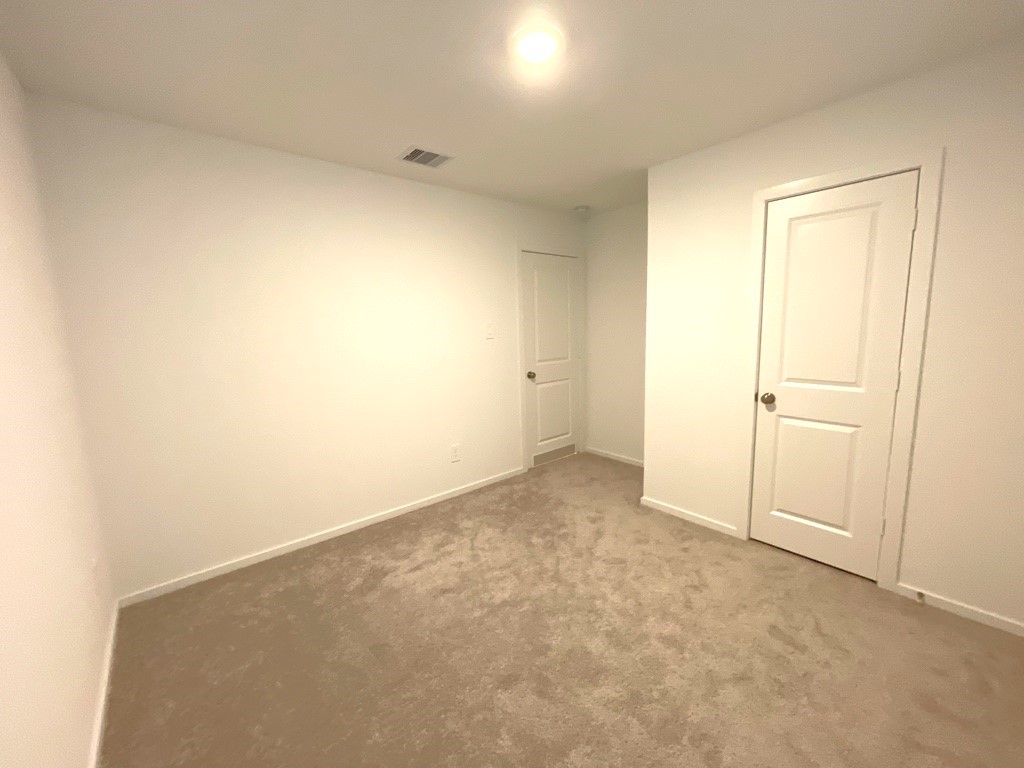 1612 Colina Creek Conroe, TX 77301 - Photo 9 of 33 an empty room with white door