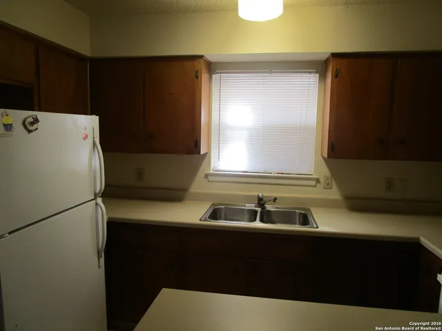a kitchen with a sink and a refrigerator