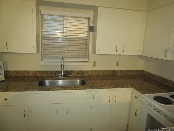 a kitchen with sink and cabinets