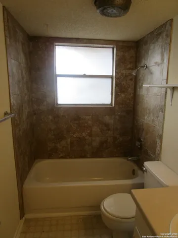a bathroom with a toilet bathtub and shower