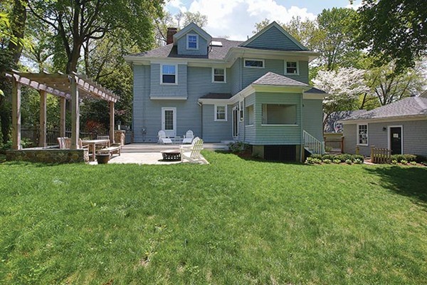 25 Woodside Road Newton, MA 02460 - Photo 12 of 13 a front view of a house with a yard table and chairs