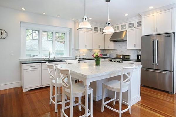 25 Woodside Road Newton, MA 02460 - Photo 5 of 13 a kitchen with granite countertop a sink appliances a counter space and a window