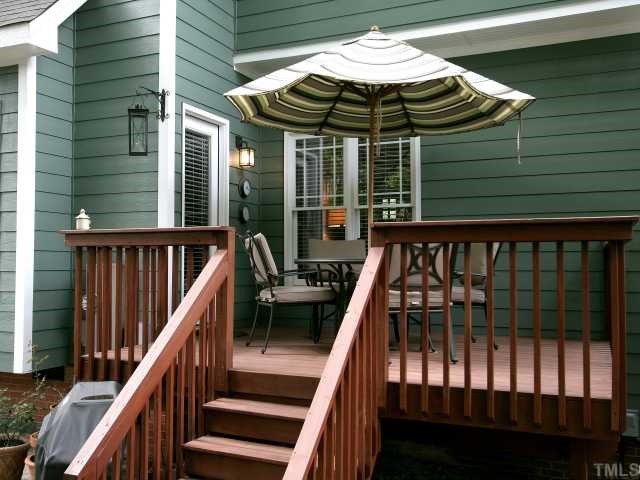 705 Scotts Ridge Trail Apex, NC 27502 - Photo 11 of 12 Dine al fresco or just relax on this raised deck and enjoy the verdant backyard.