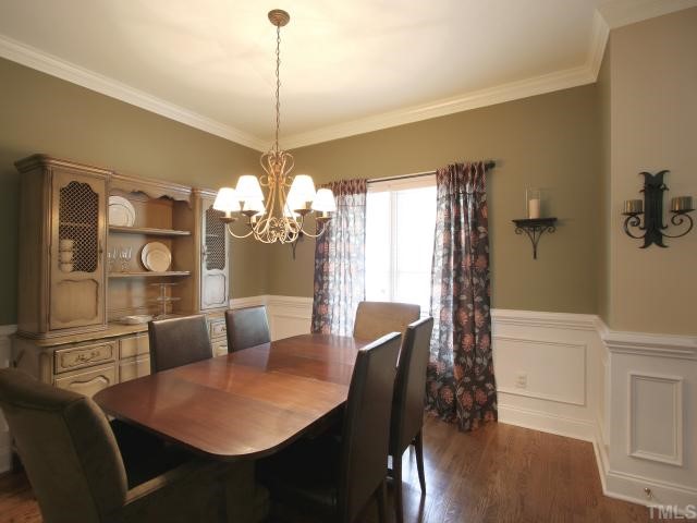 705 Scotts Ridge Trail Apex, NC 27502 - Photo 4 of 12 Entertain in style with this lovely dining room. Raised panel wainscot with chair rail. Crown molding. Hardwood floor. New oil rubbed bronze light fixture.