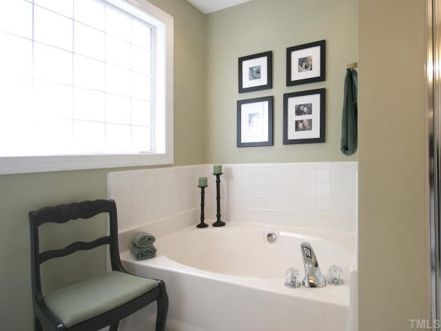 705 Scotts Ridge Trail Apex, NC 27502 - Photo 9 of 12 Pamper yourself with this luxurious master bath. Large oval soaking tub and separate shower. Glass block window. Separate toilet enclosure. Cultured marble vanity.