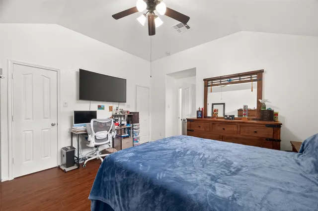 a bed room with a bed and a television