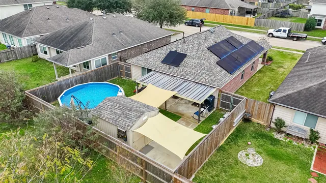 an aerial view of a house with a garden and swimming pool