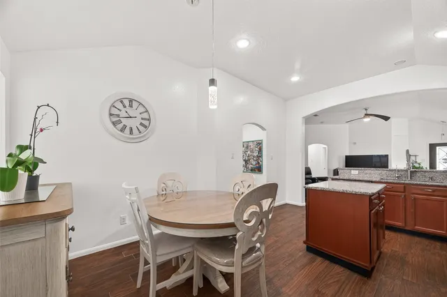a view of a dining room with furniture and wooden floor