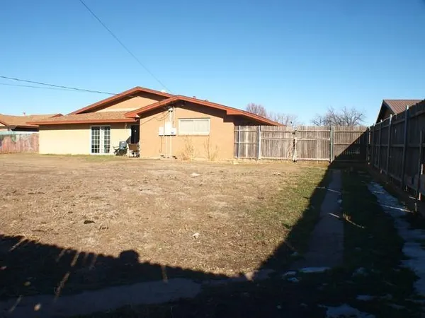a view of house with backyard and garden