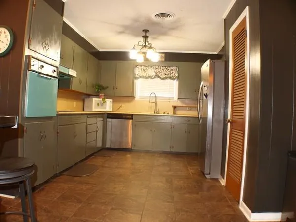a kitchen with stainless steel appliances a sink and a refrigerator