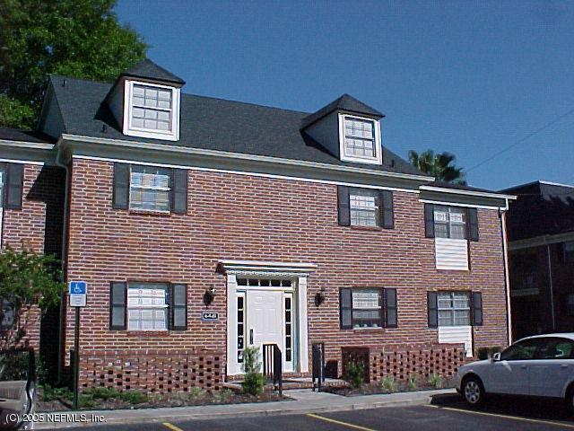 a front view of a building with parking space