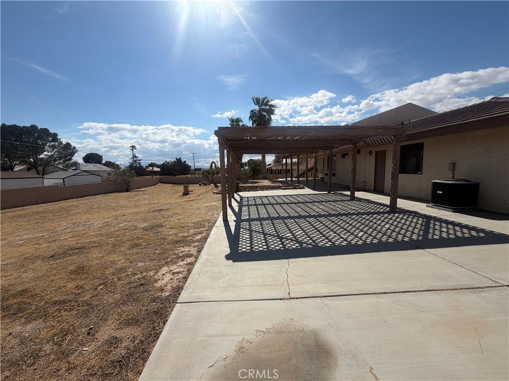 19609 Seneca Road Apple Valley, CA 92307 - Photo 33 of 37 a view of a patio with table and chairs with wooden floor