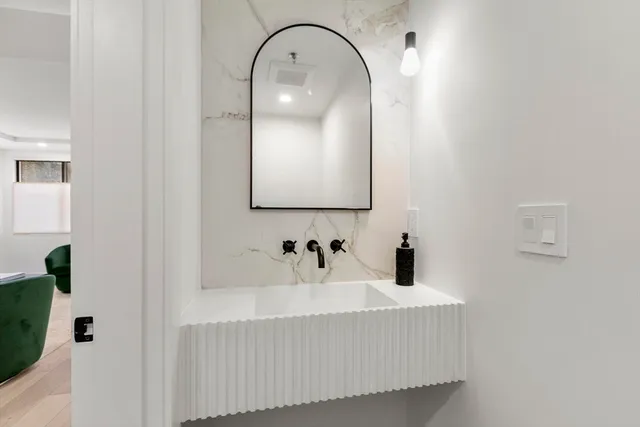 a bathroom with a sink and mirror