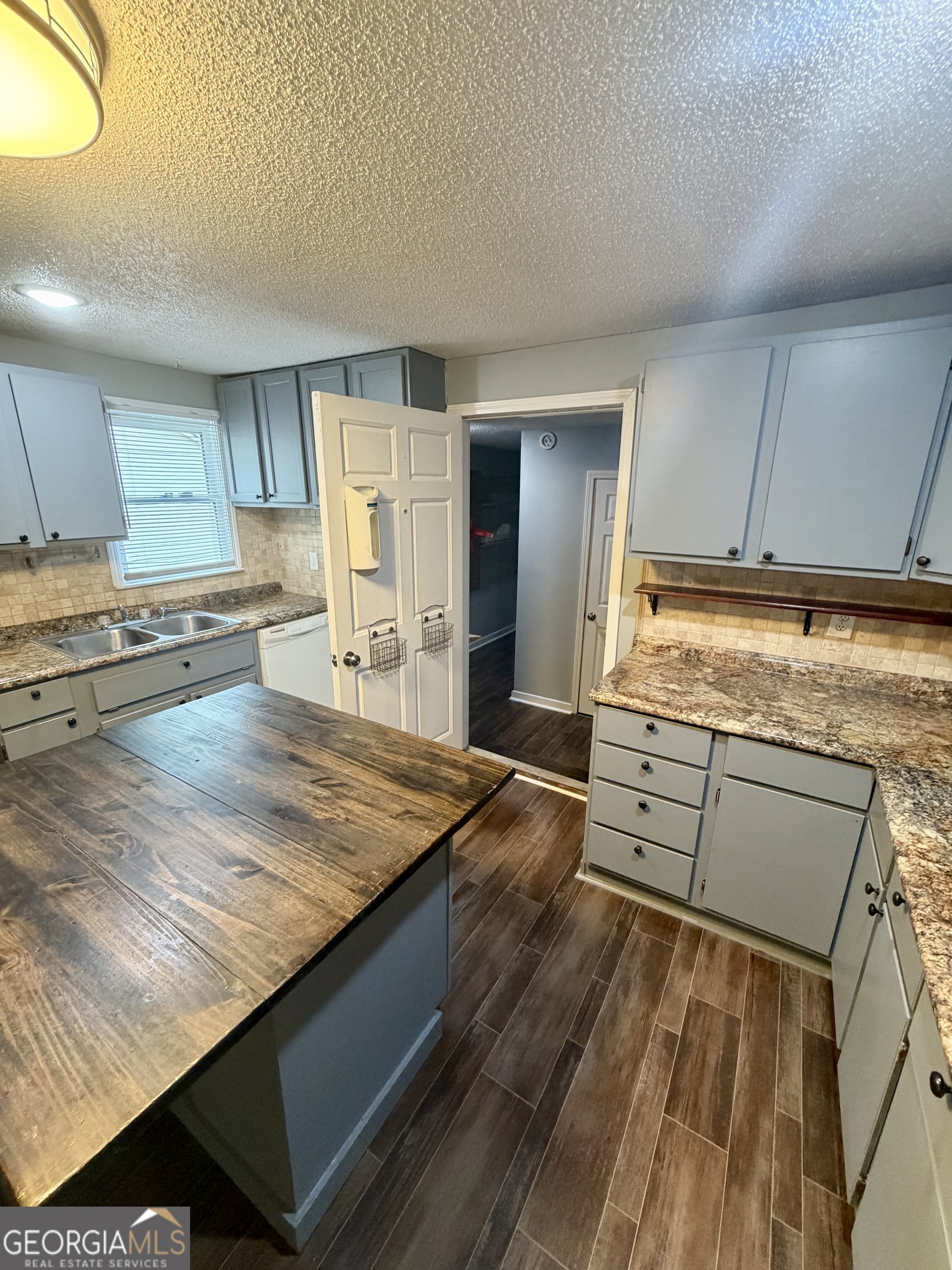 666 Woolfolk Street Macon, GA 31217 - Photo 32 of 60 a kitchen with stainless steel appliances granite countertop a sink stove and cabinets