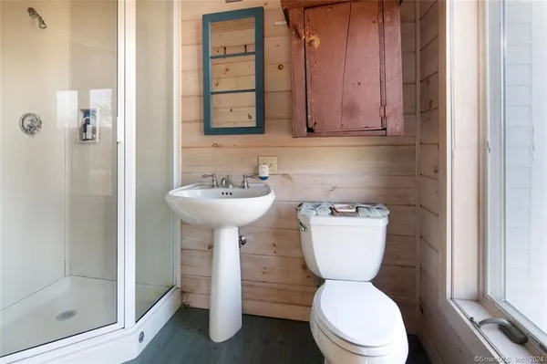 a bathroom with a toilet sink and mirror