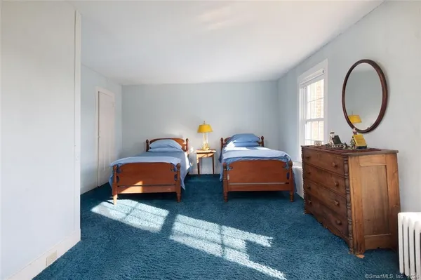 a bedroom with bed and a car parked