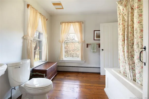 a bathroom with a granite countertop toilet a sink and a bathtub