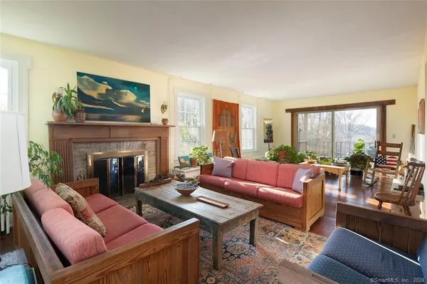 a living room with furniture large window and a fireplace