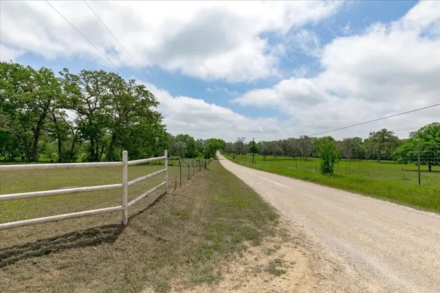 a view of a swimming pool with a yard