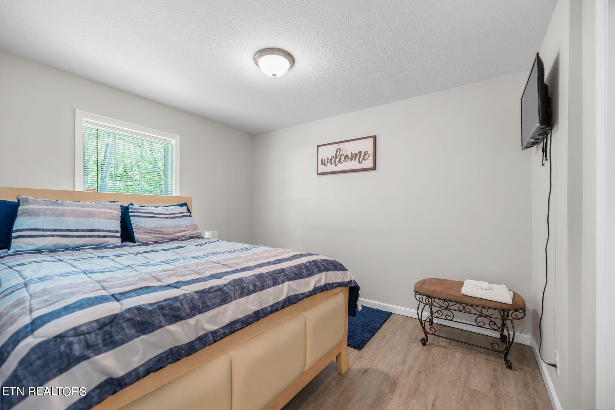 104 Tucker Road Oak Ridge, TN 37830 - Photo 13 of 28 a bedroom with a bed and a chair