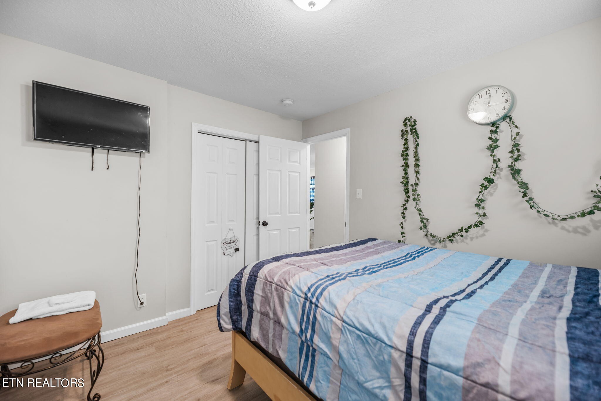 104 Tucker Road Oak Ridge, TN 37830 - Photo 14 of 28 a bedroom with a bed and a flat screen tv