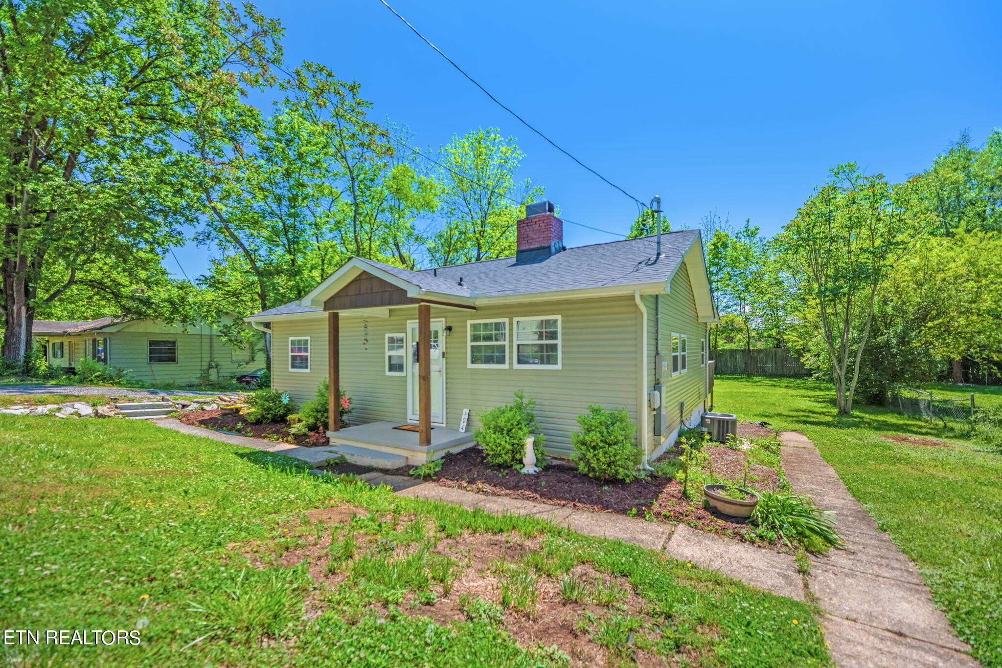 104 Tucker Road Oak Ridge, TN 37830 - Photo 2 of 28 a front view of a house with garden