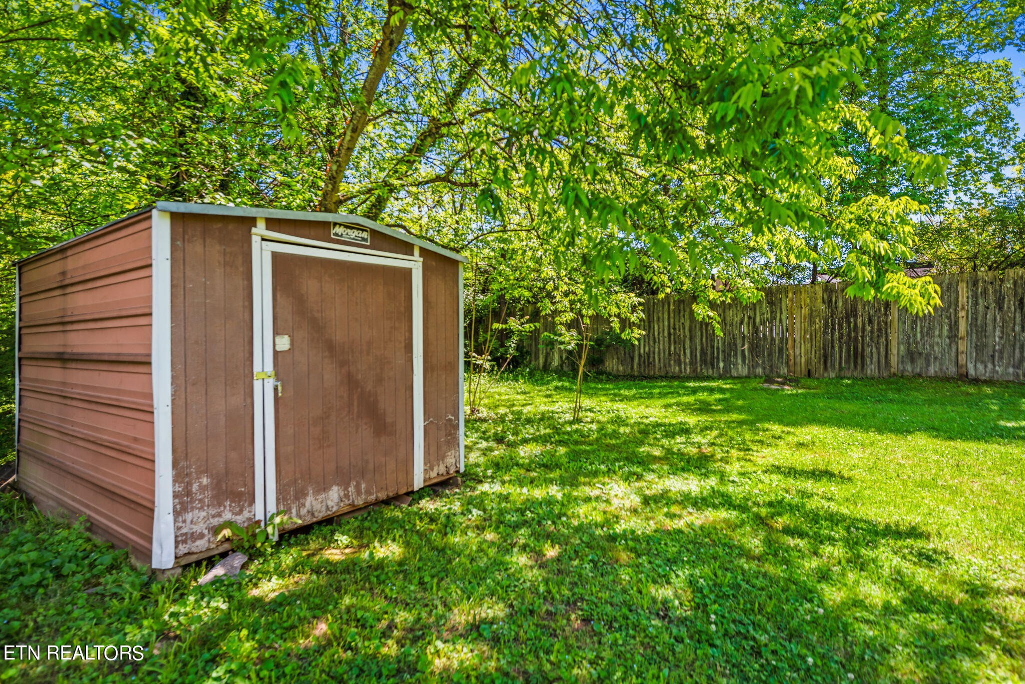 104 Tucker Road Oak Ridge, TN 37830 - Photo 26 of 28 a view of backyard with potted plants and large tree