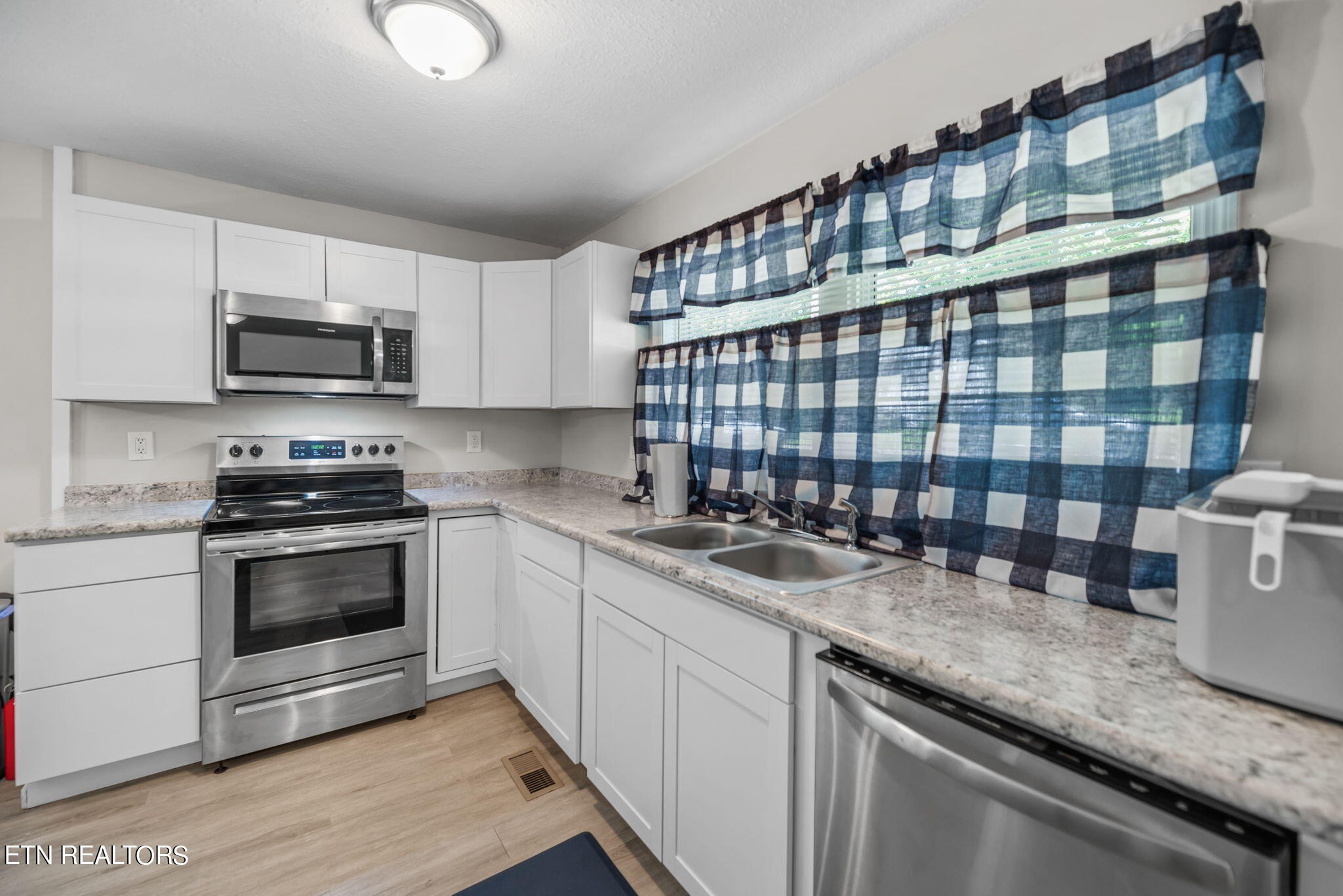 104 Tucker Road Oak Ridge, TN 37830 - Photo 4 of 28 a kitchen with a sink and a stove top oven