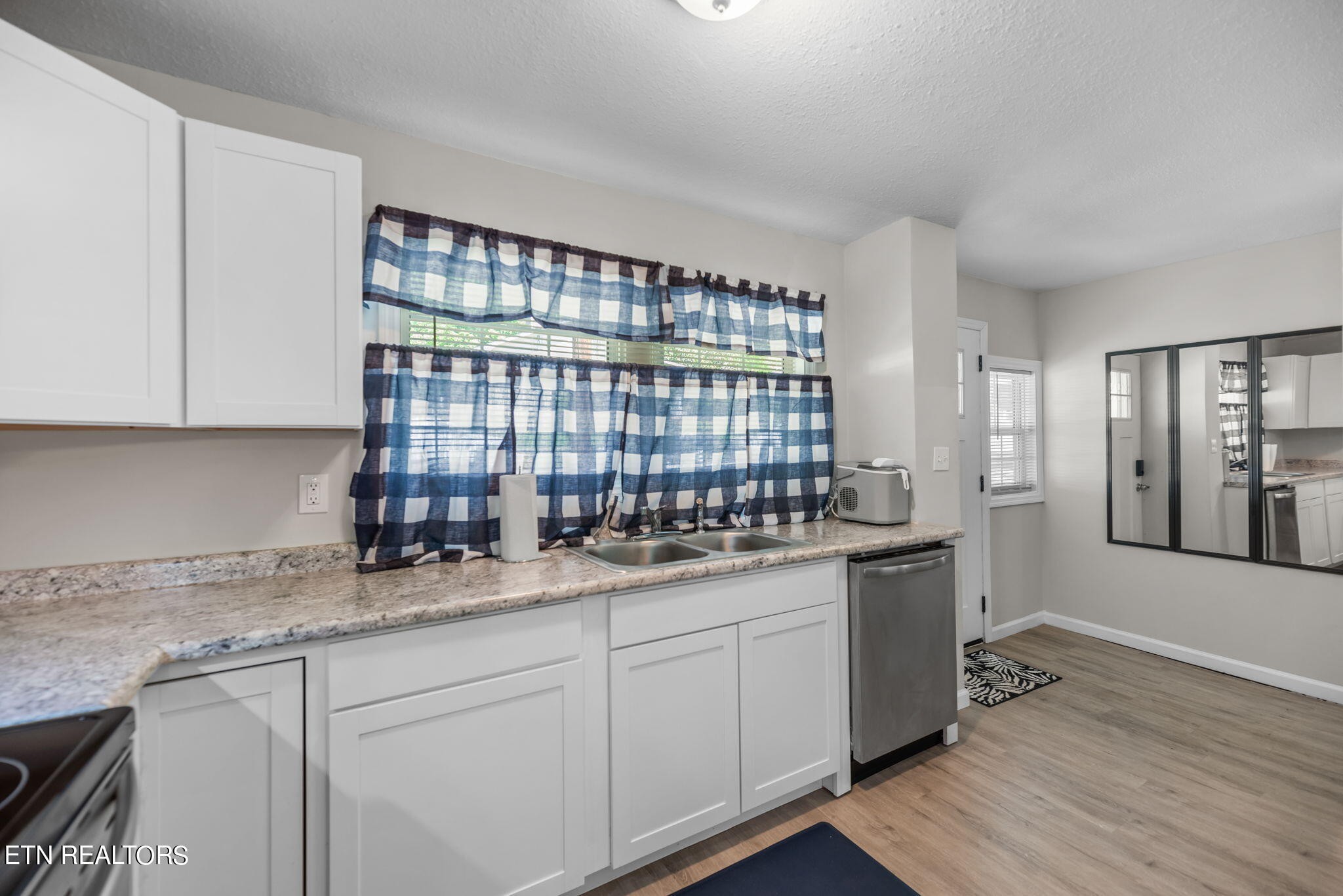104 Tucker Road Oak Ridge, TN 37830 - Photo 5 of 28 a kitchen with granite countertop a sink window and cabinets