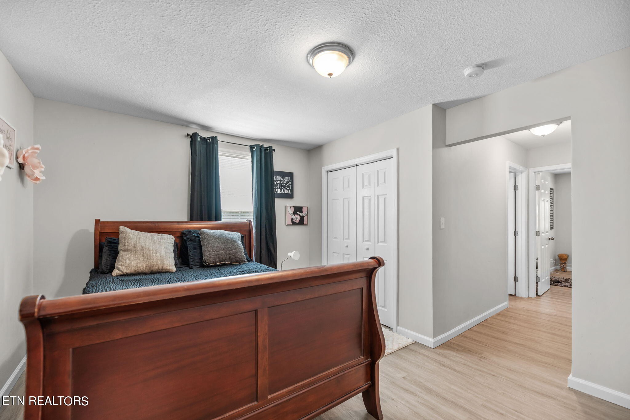 104 Tucker Road Oak Ridge, TN 37830 - Photo 10 of 28 a bedroom with bed and wooden floor