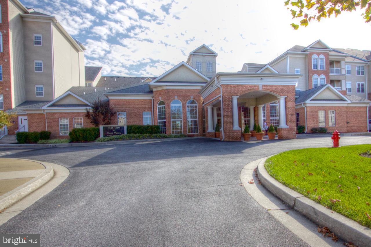 400 Symphony Circle, Unit 74B Cockeysville, MD 21030 - Photo 1 of 36 a front view of a building with a garden
