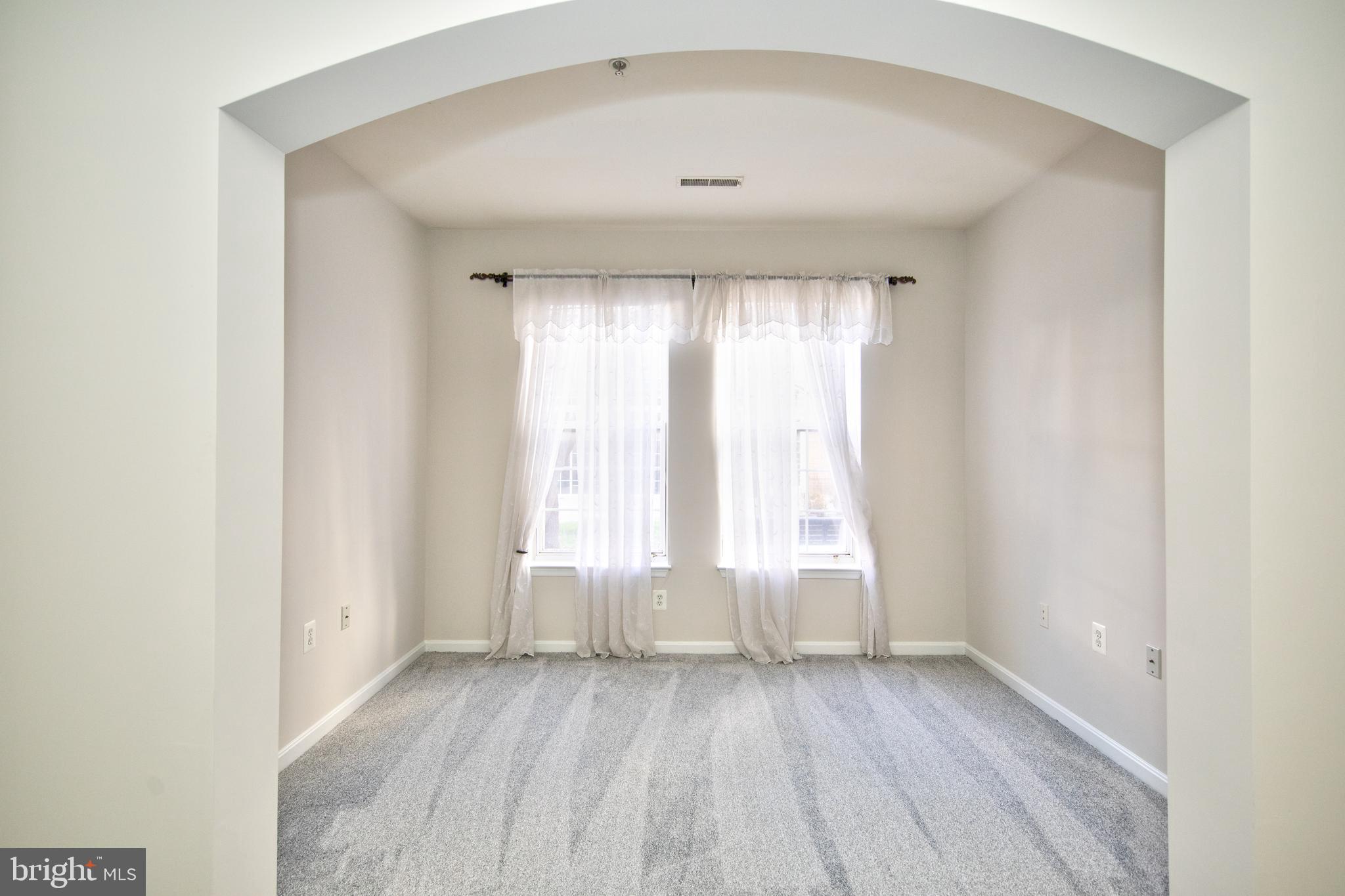 400 Symphony Circle, Unit 74B Cockeysville, MD 21030 - Photo 15 of 36 an empty room with wooden floor and windows