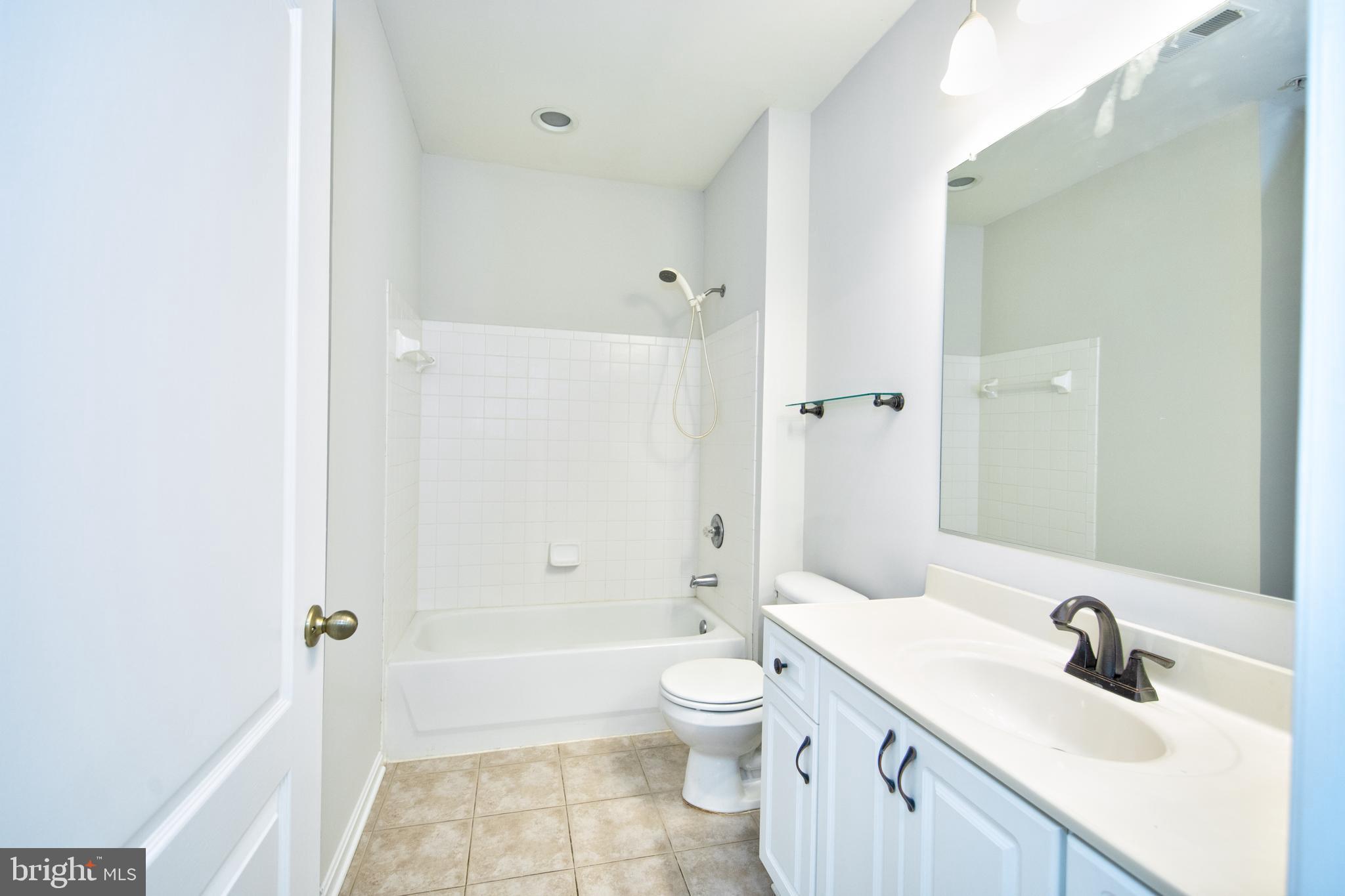 400 Symphony Circle, Unit 74B Cockeysville, MD 21030 - Photo 20 of 36 a bathroom with a sink a toilet and shower